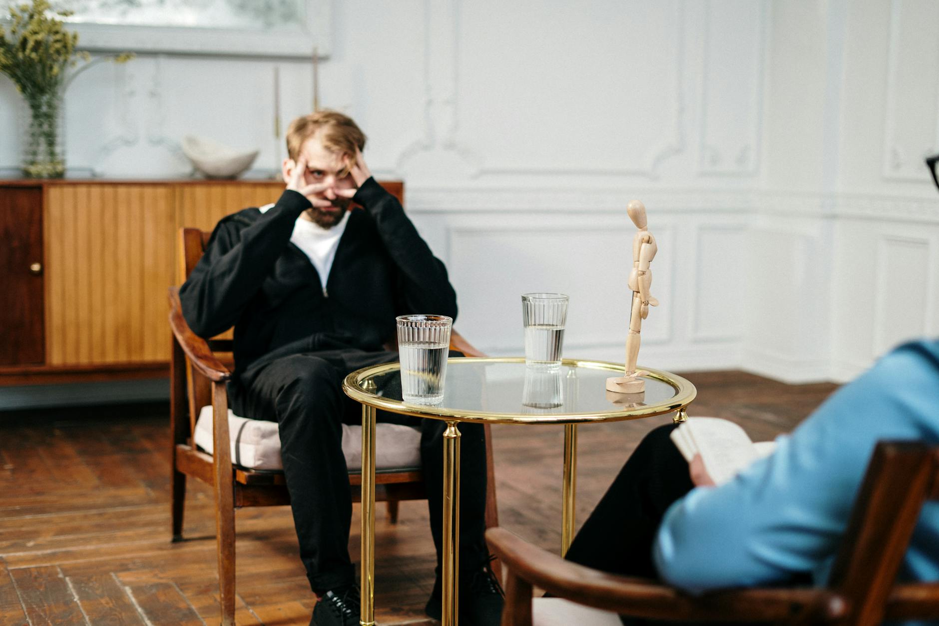 Man consulting with therapist in a cozy, well-lit office. Emotional support and mental health focus. - mental health reset