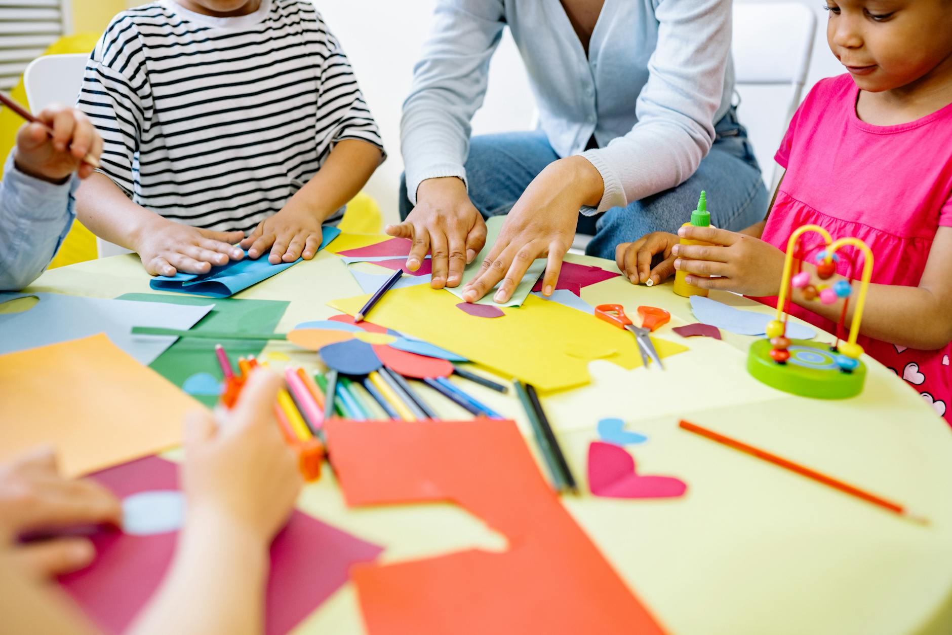 Group of diverse children enjoying creative art activities in a vibrant classroom setting. - preschool playdate ideas