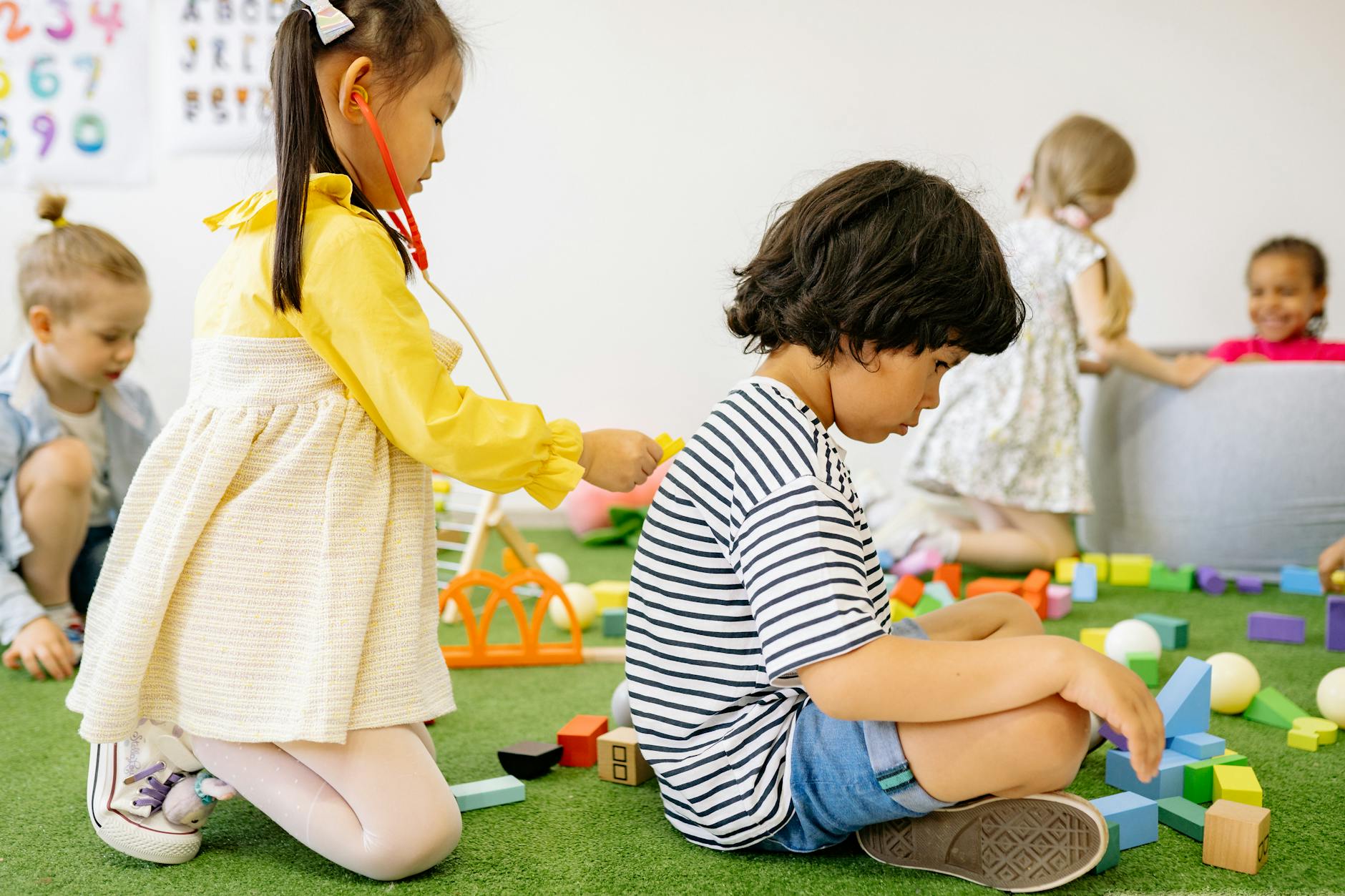 Joyful children engaged in playtime at a cheerful kindergarten setting. - preschool playdate ideas