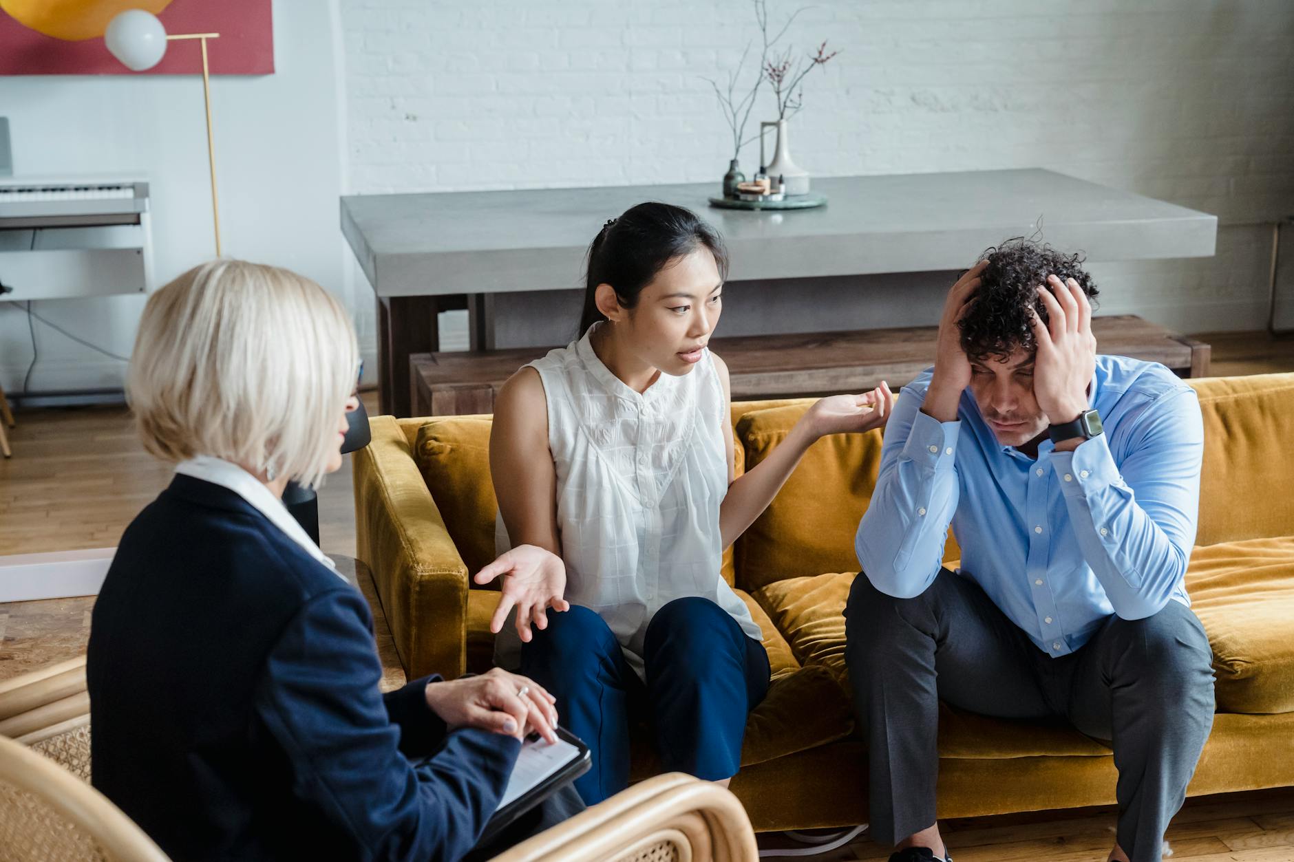 A couple having a therapy session with a psychologist in a modern office setting. - relationship drifting therapy
