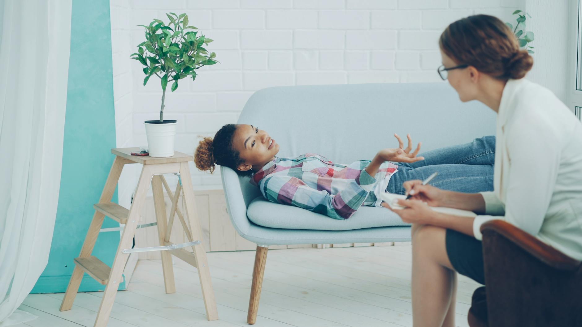Cozy therapy office with client and therapist during a session. - therapist for relationship anxiety