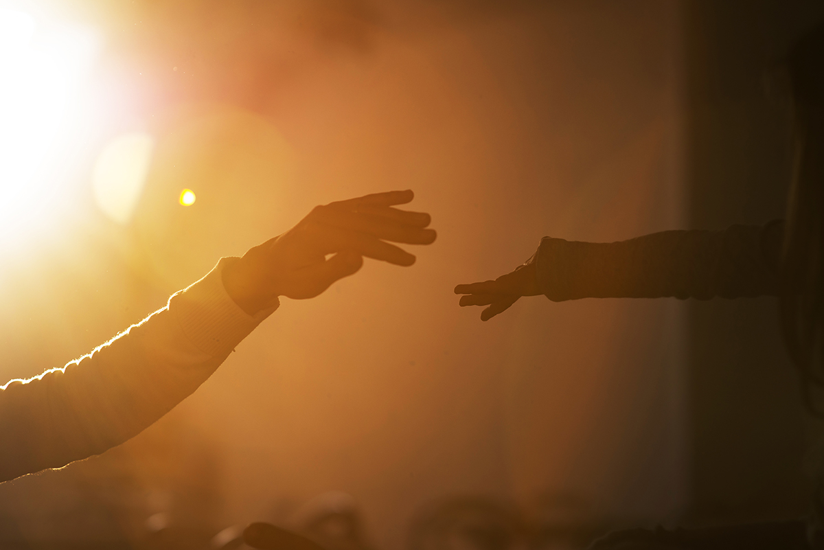 Two hands reaching towards each other, symbolizing the process of healing a toxic relationship