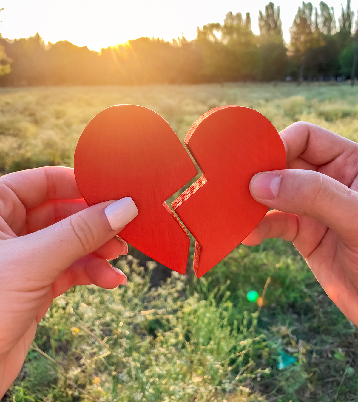 A pair of hands fixing a broken heart, symbolizing the process of rebuilding trust