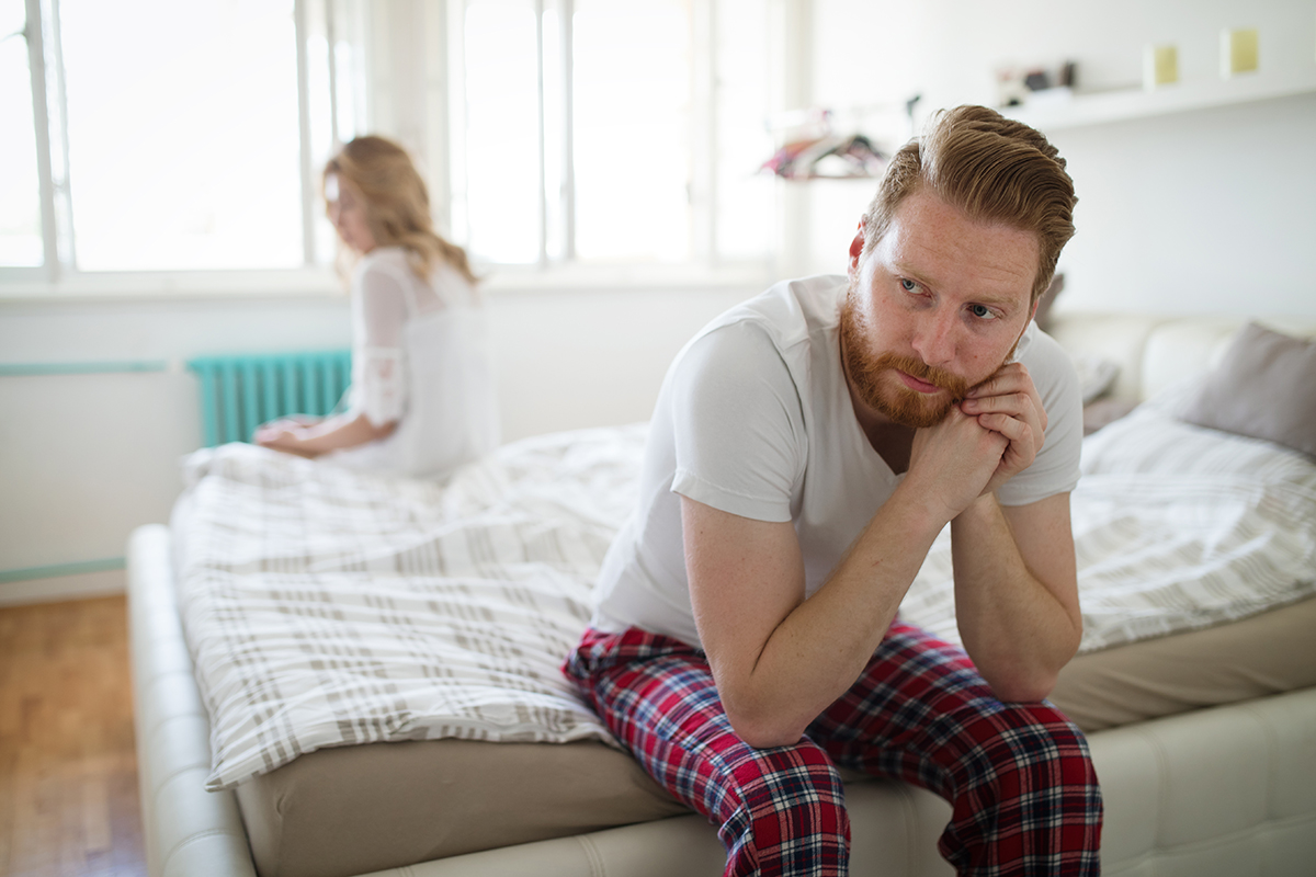 Two people sitting apart, symbolizing tension in a relationship due to overthinking