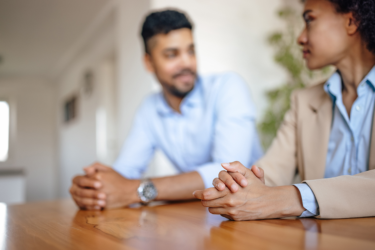 Adult couple engaged in active listening during a meaningful conversation.