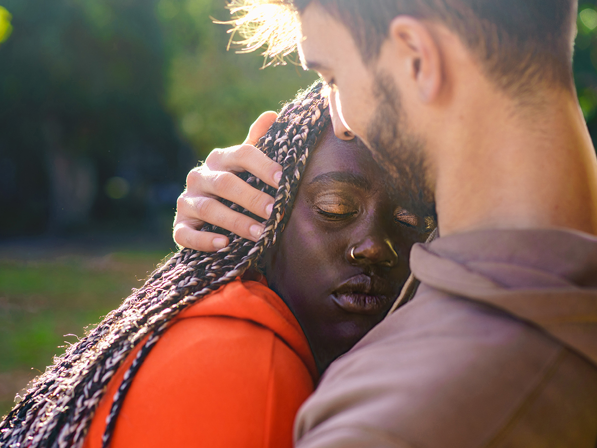 Multi-ethnic lovers hugging, symbolizing the support and care needed when dating someone who was abused by a narcissist