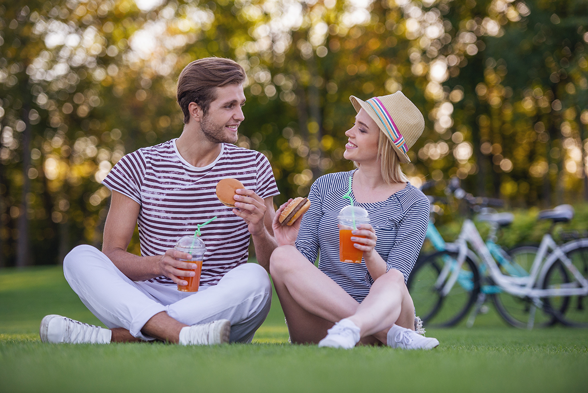 Couple discussing while dating with a background of multiple partners