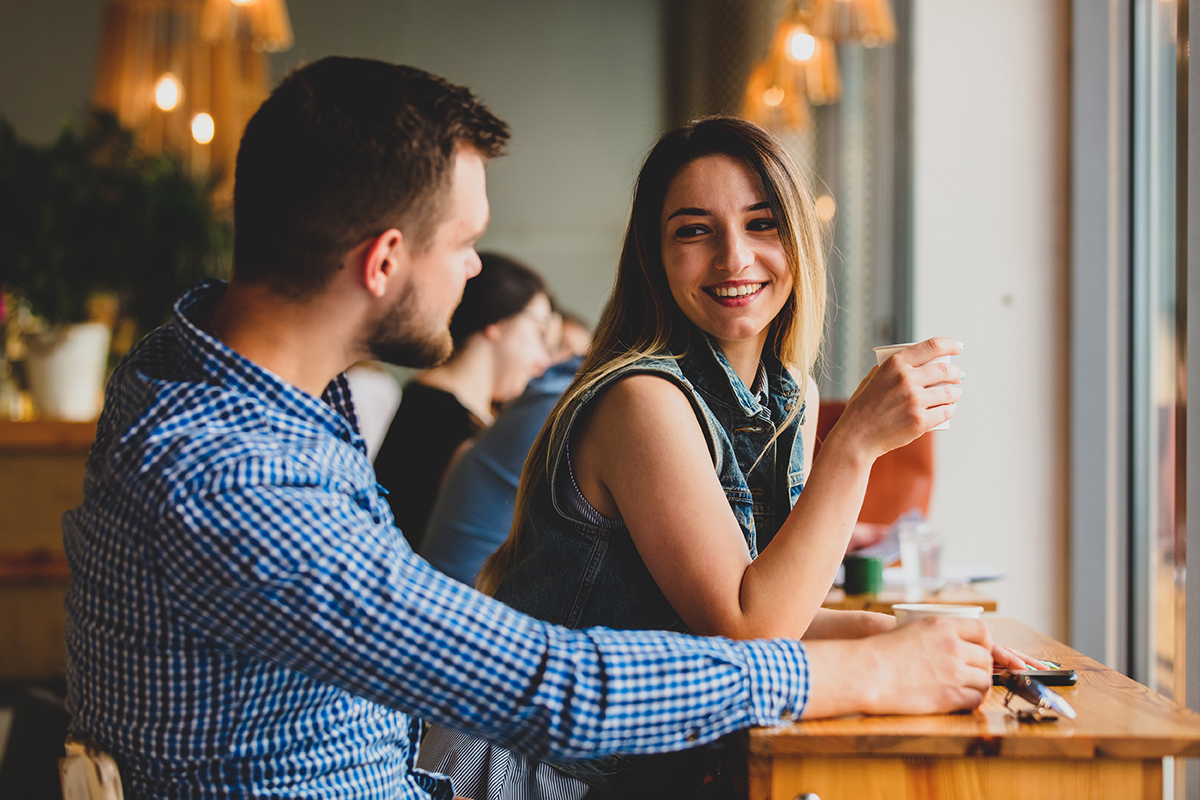 Couple sharing a genuine conversation over coffee