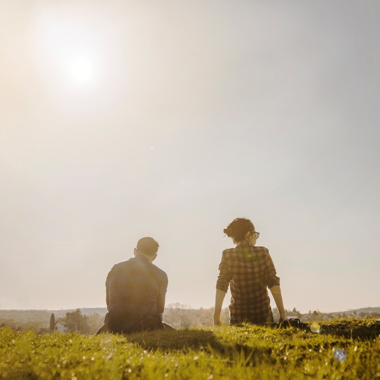 Couple sitting apart, looking away from each other