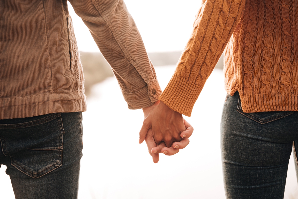 Couple holding hands expressing love without words