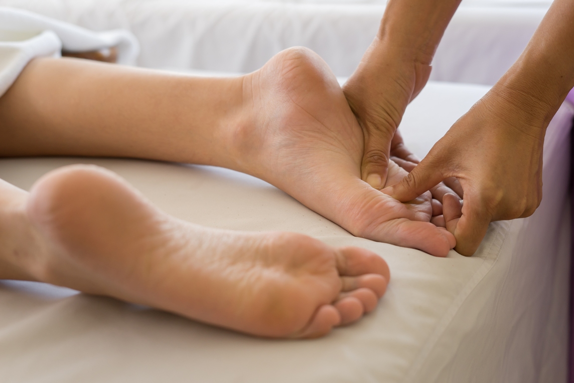 Massaging feet as part of sensual massage to enhance connection and relaxation between partners