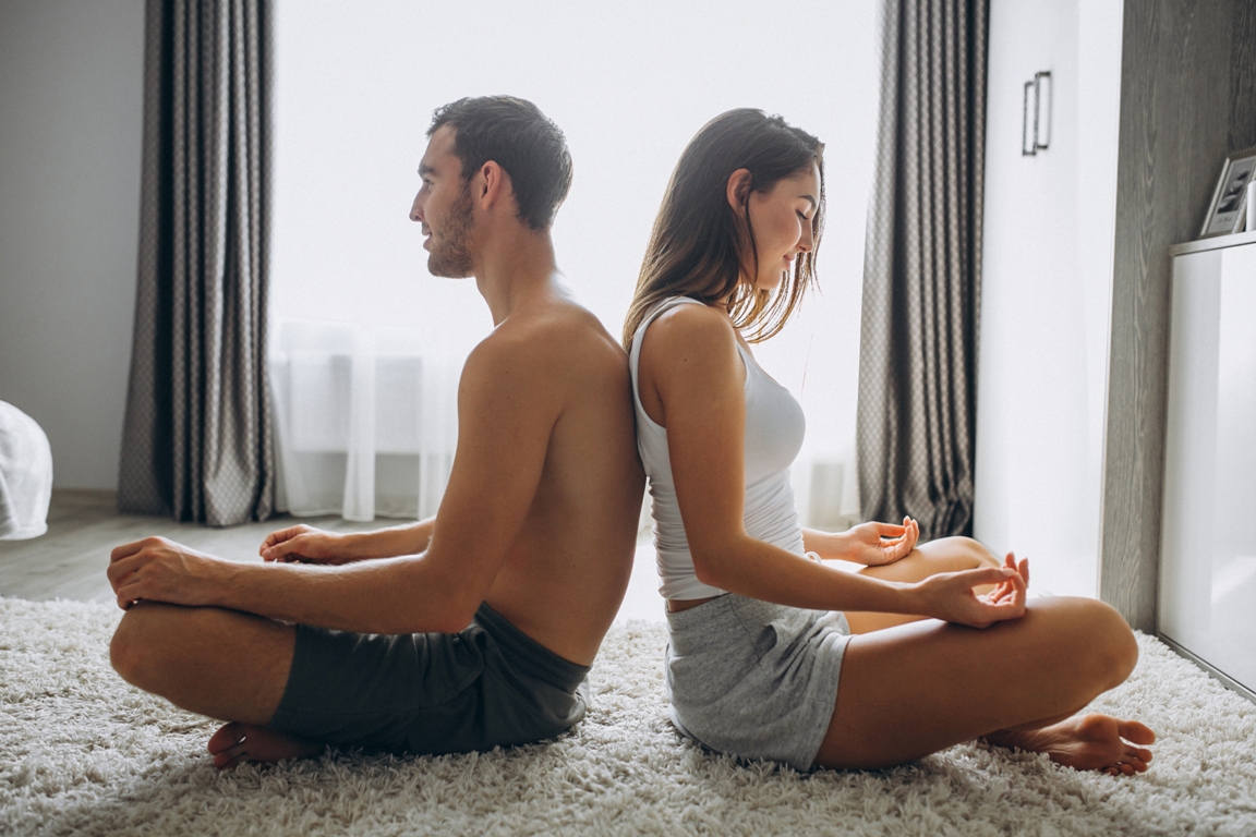 Couple practicing tantric breathing together for intimacy enhancement